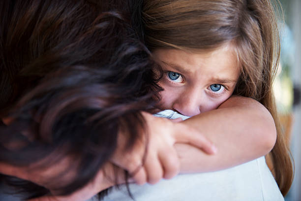 Mommy makes everything better Closeup shot of a upset little girl hugging her mom around the neck fear stock pictures, royalty-free photos & images