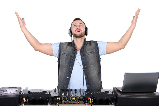 Cool DJ at work. Happy young men spinning on turntable while isolated on white