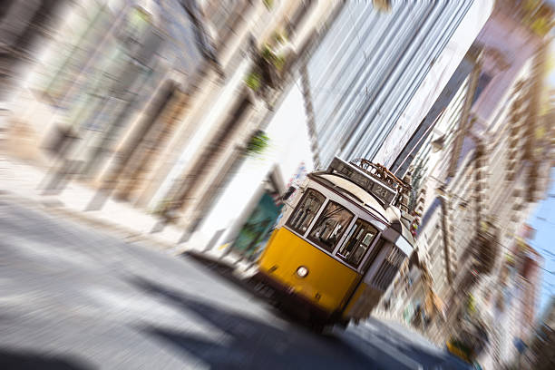 Typical Lisbon road with a yellow tram, Portugal.