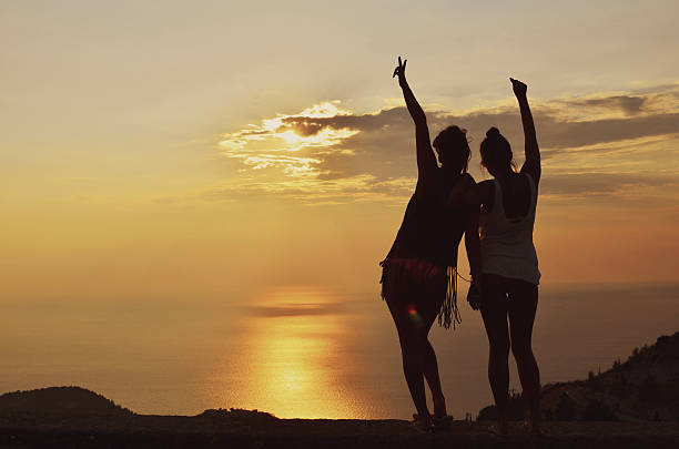 istock Happy lesbian couple enjoying beautiful sunset 494934597