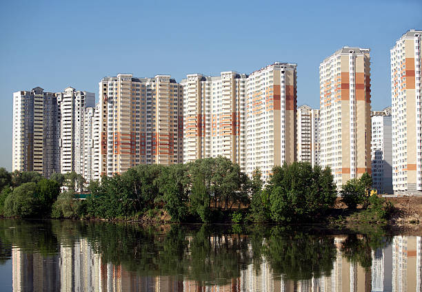 istock Many block of flats over river and clear blue sky 494936621