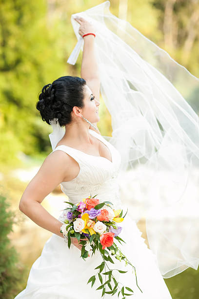 istock beautiful bride with flowers in hand 494936805