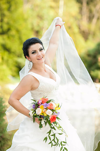 istock beautiful bride with flowers in hand 494936807