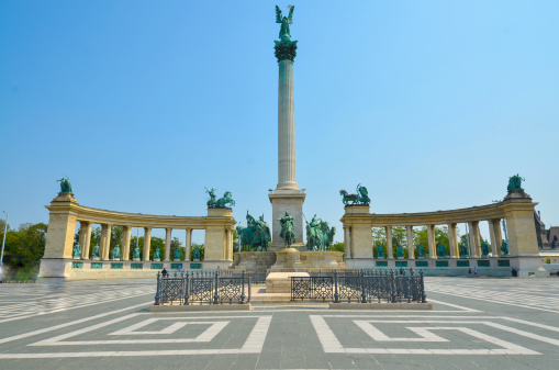 The statue of Archangel Gabriel in Heroes' Square, Budapest, Hungary. Architect Albert Schieckedanz created the square for 1896 Hungarian millennium celebrations. At the base of Gabriel's column is Arpad and the chieftains of the seven Magyar tribes who followed him. Behind the pillar the Millennium Memorial contains staues of the kings and heroes from Hungarian history.