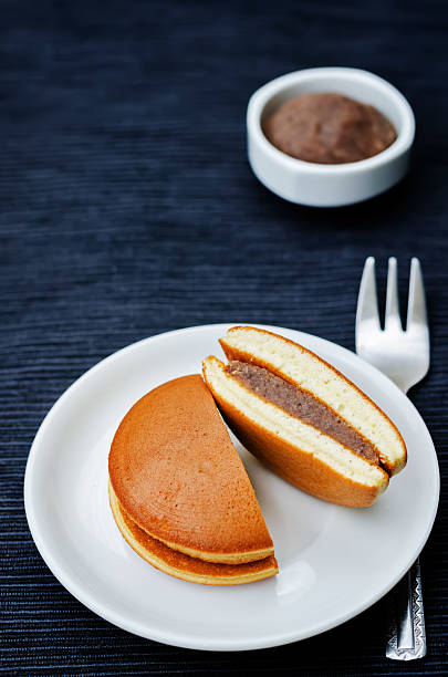 dorayaki, Japanese red bean pancakes dorayaki, Japanese red bean pancakes on a black background. toning. selective focus red bean dessert stock pictures, royalty-free photos & images