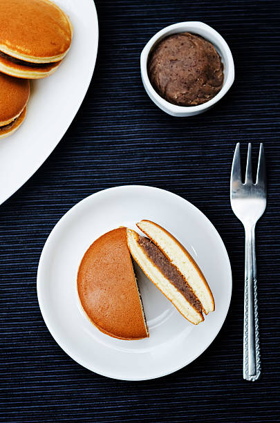dorayaki, Japanese red bean pancakes dorayaki, Japanese red bean pancakes on a black background. toning. selective focus red bean dessert stock pictures, royalty-free photos & images