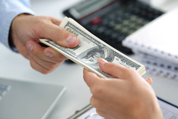 istock Man taking batch of hundred dollar bills 494939466
