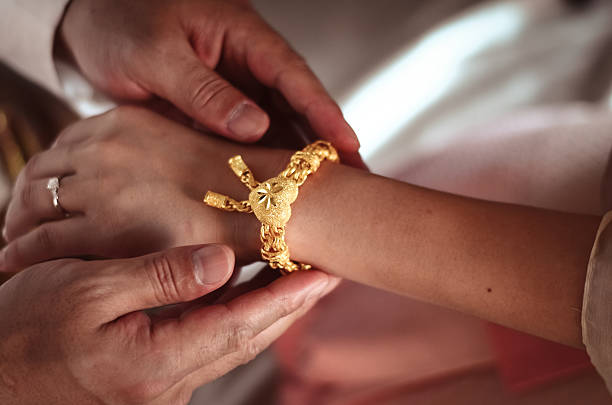 istock Groom presenting the golden bracelet as a blessing 494939685