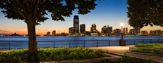 Sunset view from Manhattan of Jersey City and Hudson River waterfront with skyscrapers.