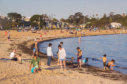 Melbourne, Australia - October 2, 2015: Williamstown Beach is crowded with beachgoers on a public holiday.