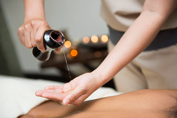 istock chiropractor pour oil into hand for massage 494944916