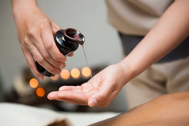 istock chiropractor pour oil into hand for massage 494945126