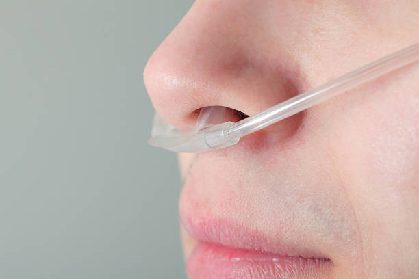 Oxygen tube in the patient's nose Oxygen tube in the patient's nose human nose stock pictures, royalty-free photos & images
