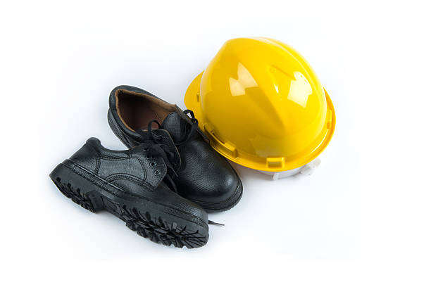 istock Yellow hard hat and leather boots, protective equipment in const 494948570