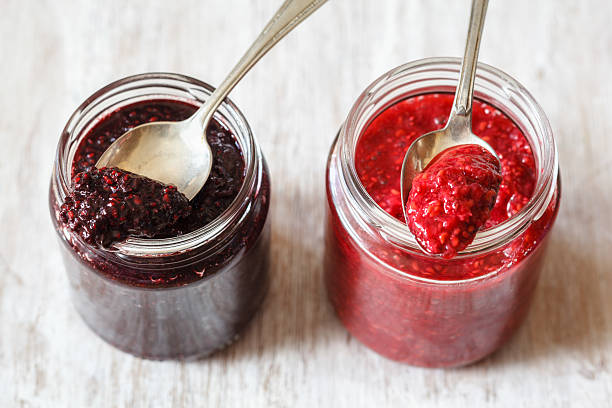 Blackberry and raspberry jam with chia seeds in glasses stock photo