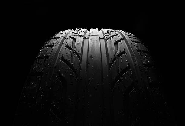 istock Wet car tire on black macro 494955313