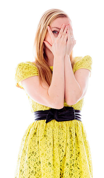 istock Young woman peeking through hands covering face 494956209