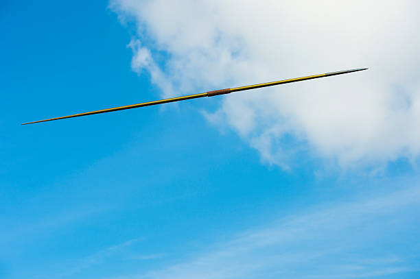 Javelin in Mid-air Side view of yellow javelin in mid-air javelin stock pictures, royalty-free photos & images