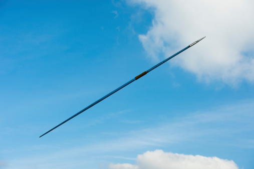 Side view of blue javelin in mid-air