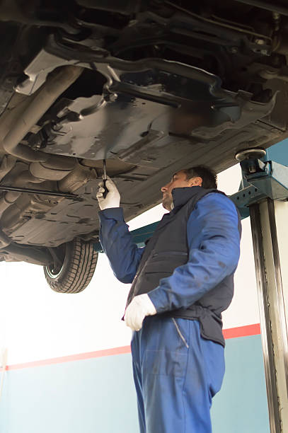 istock auto mechanic who looks under a car for inspection 494957693