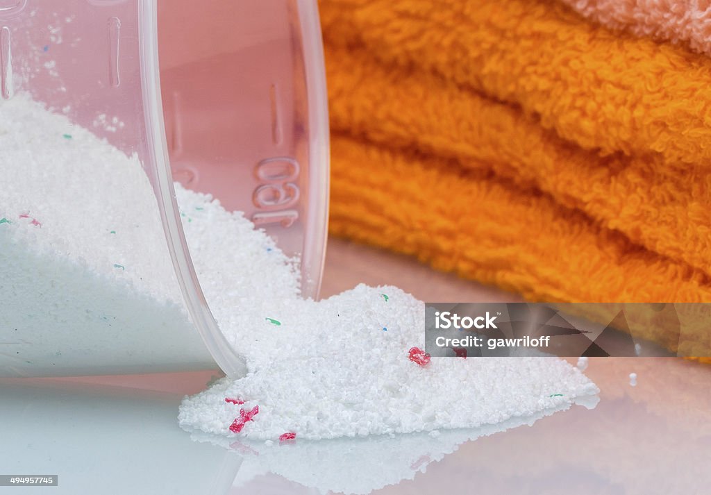 Detergent for washing machine in laundry with towels Detergent for washing machine in laundry with towels in the white background. Arrangement Stock Photo