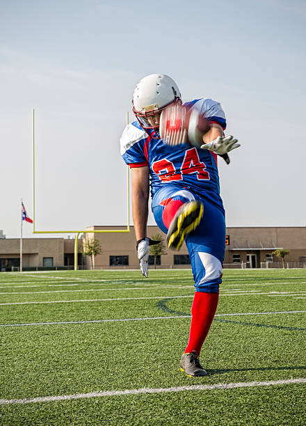 istock Football Player Punts the ball 494959605