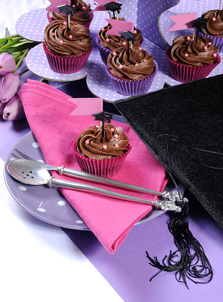istock Graduation day pink and purple party table setting - vertical. 494959807