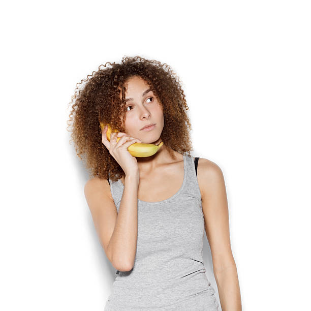 istock Young pretty woman making fun with banana 494960292
