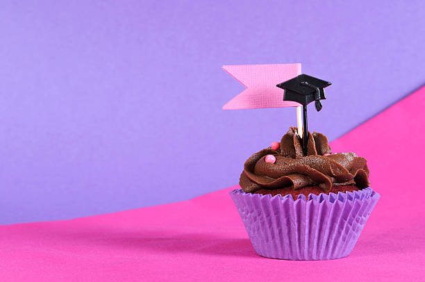 istock Graduation day pink and purple party cupcake with copy space. 494960293