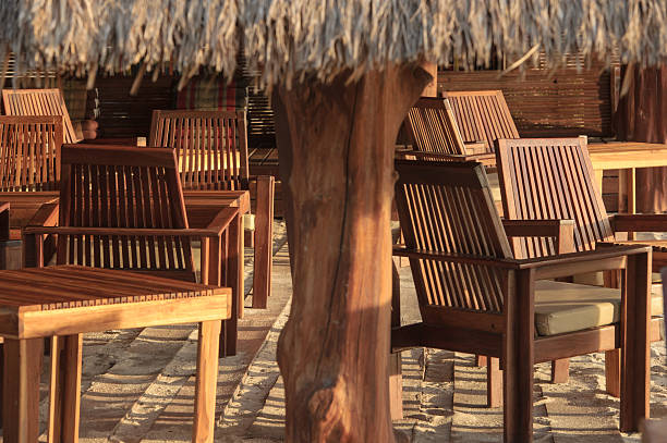 istock Beach cafe with wooden tables and chairs 494960549