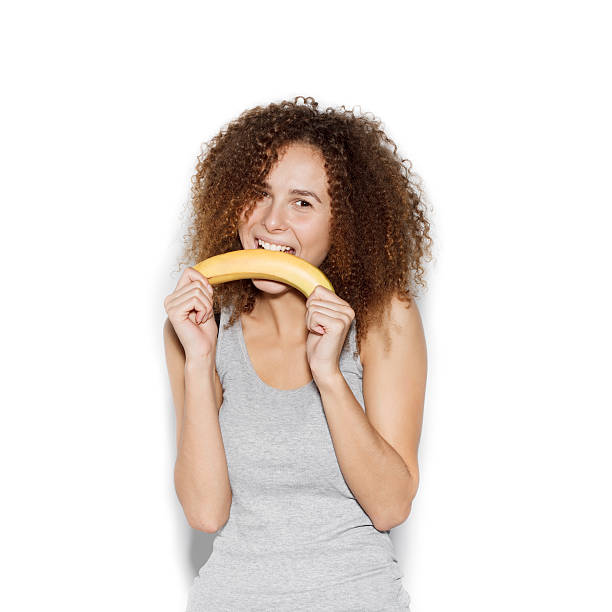 istock Young pretty woman making fun with banana 494960576