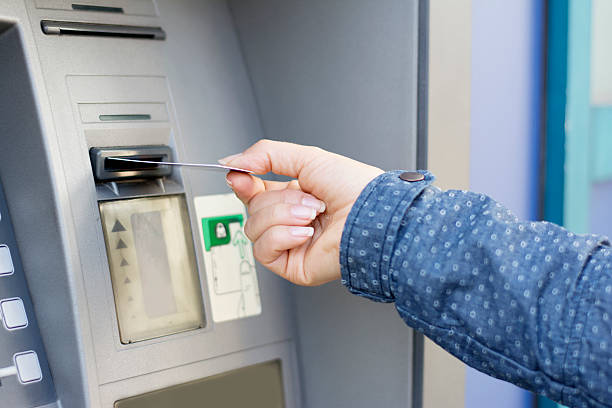 istock Woman in blue jacket at ATM 494960658