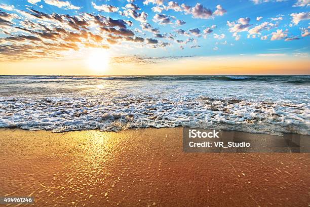 Colorful Ocean Beach Sunrise With Deep Blue Sky Stock Photo - Download Image Now - 2015, Bay of Water, Beach