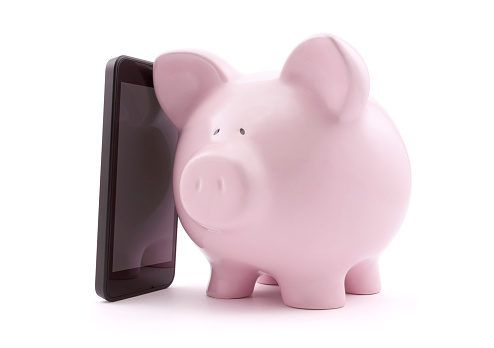 Piggy bank with mobile phone. Clipping path included