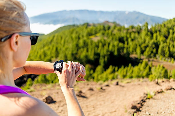 istock Cross country runner looking at sport watch 494961471