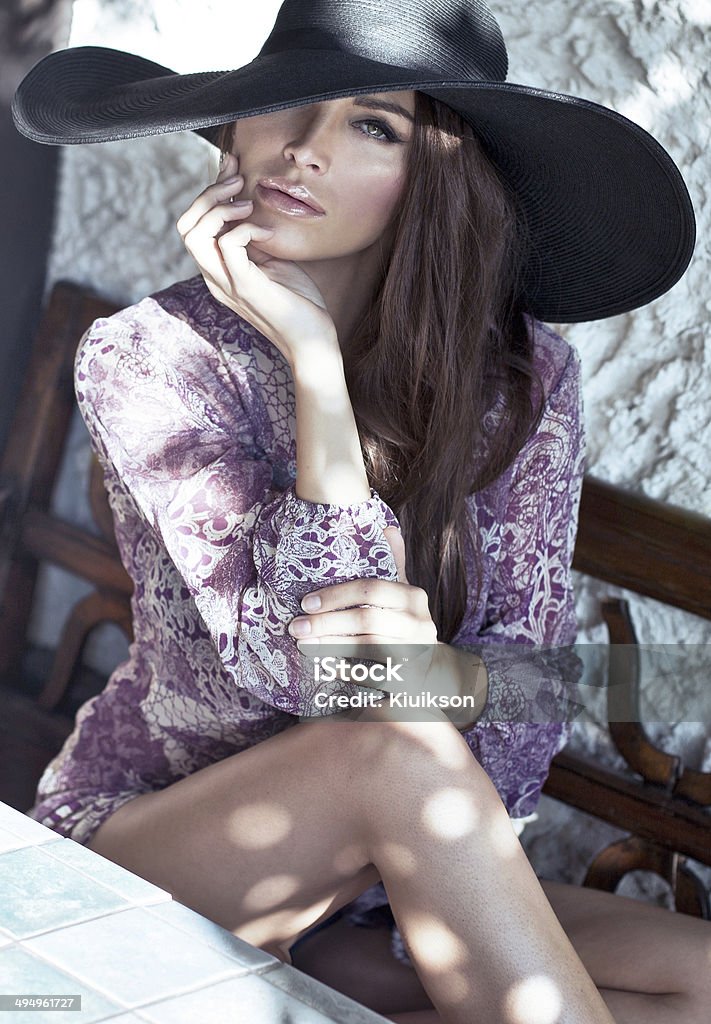 Attractive woman wearing big black hat Lifestyles Stock Photo