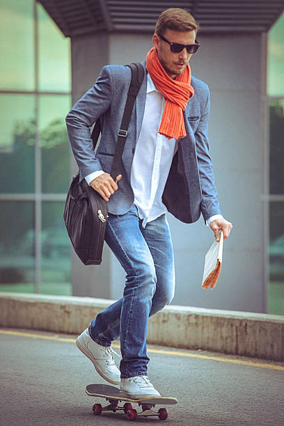 istock Young casual businessman comuting to work skateboarding. 494963240