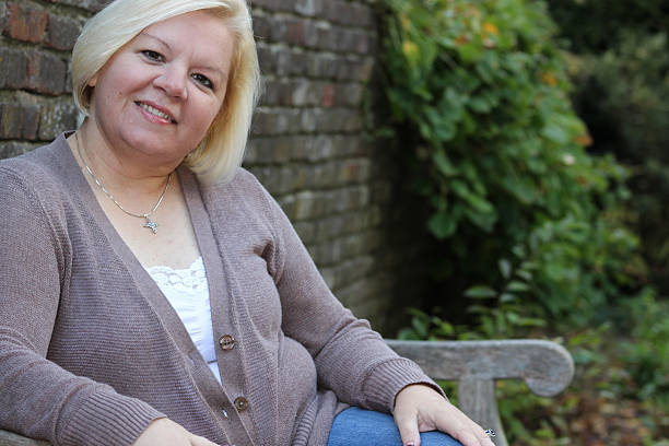 istock Smiling Woman on Bench Poses For Camera 494963944