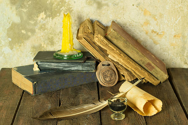 istock Old books, candle and feather amulet with ink 494974462