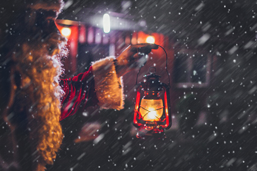 Santa Claus is lighting his way through a snowstorm with a lanternSanta Claus is lighting his way through a snowstorm with a lantern