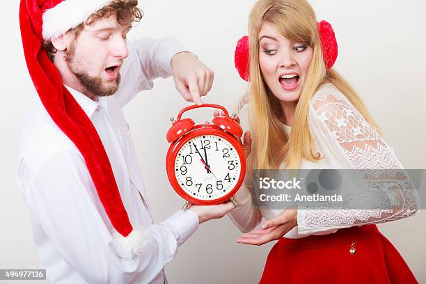 Scared Couple Woman And Man With Alarm Clock Stock Photo - Download Image Now - 12 O'Clock, 2015, Adult