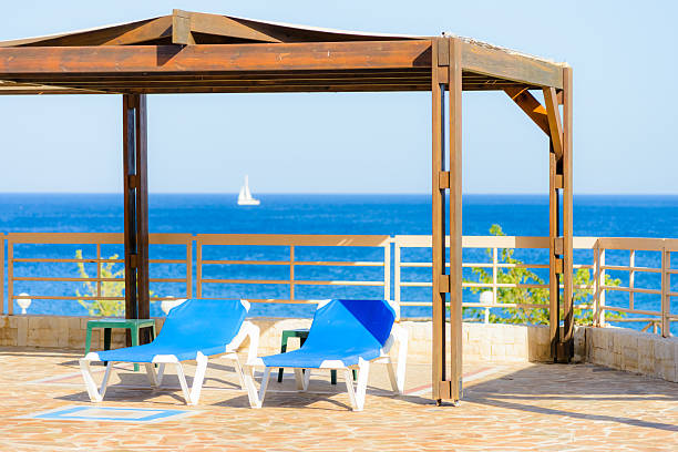 istock swimming pool with sun loungers 494979105
