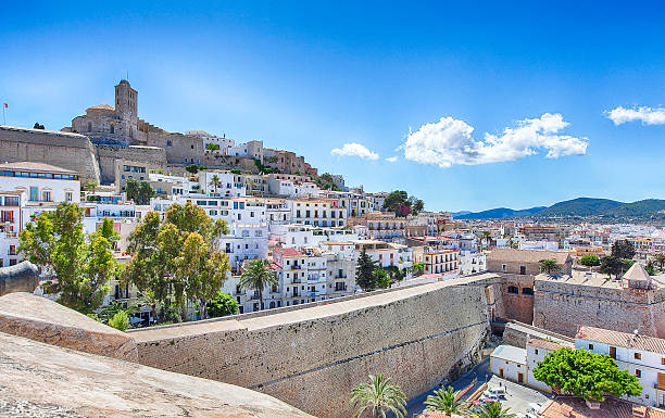 Ibiza old town/city : Sunny & Colorful Panorama Sunny Panorama with a blue sky and few white clouds from the old town of Ibiza (old city of Eivissa) in Spain (Balearic Islands). Photo taken from the stone wall surrounding the city with a view of the Cathedral. ibiza town stock pictures, royalty-free photos & images