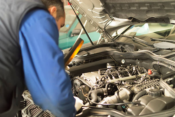 istock auto mechanic makes inspection and check a diesel engine car 494979799