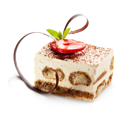 Tiramisu - Classical Dessert with Cinnamon and Coffee. Garnished with Strawberry and Mint