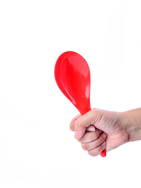 istock Hand holding red ladle isolated on white background 494983201