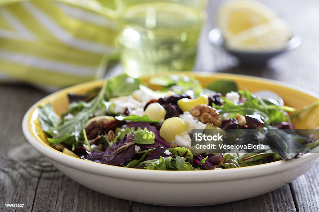 Salad with baked rhubarb Salad with baked rhubarb, feta, raisins and walnuts Appetizer Stock Photo