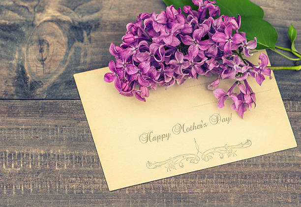 istock lilac flowers on wooden background 494984001