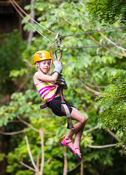 istock Young girl on a jungle zipline 494984611