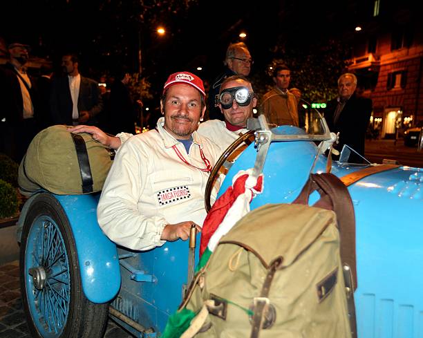 The blue car Rome, Italy - May, 17th, 2013: In the central Via Veneto, outdoors among the fans and the curious, a crew of runners on a 1930s-era car, during a stage of the reenactment of the hystoric race "Mille Miglia" hystoric stock pictures, royalty-free photos & images